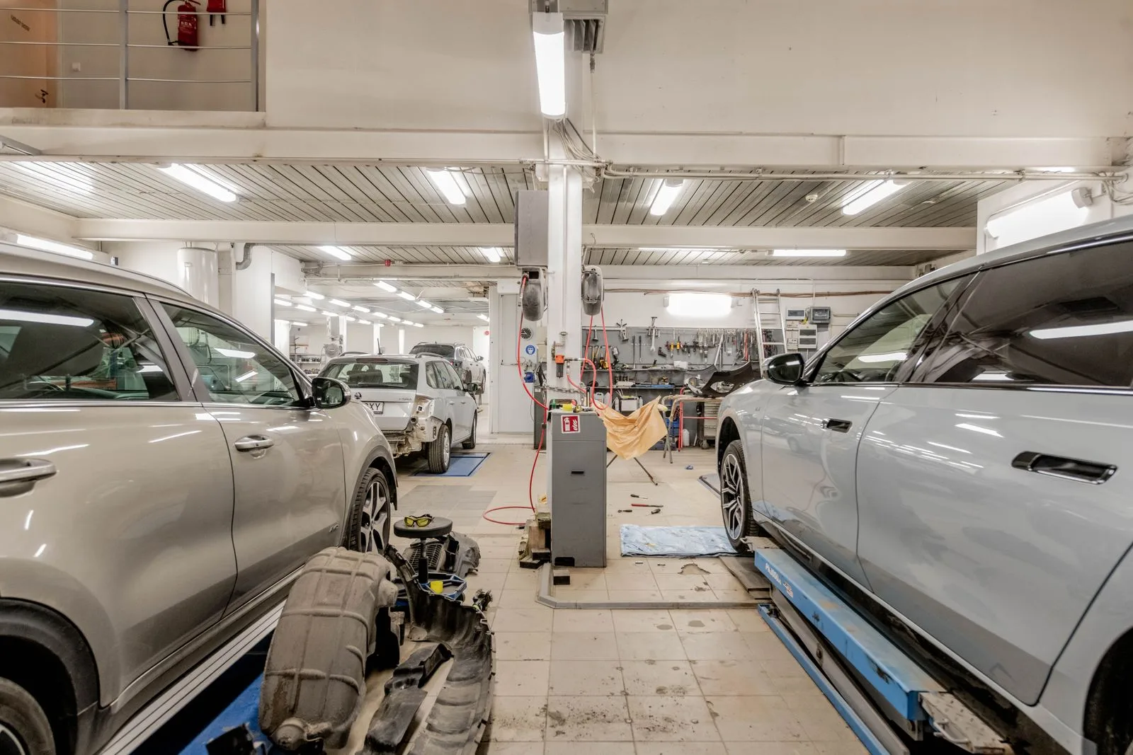 Interior of an auto repair workshop with vehicles undergoing maintenance