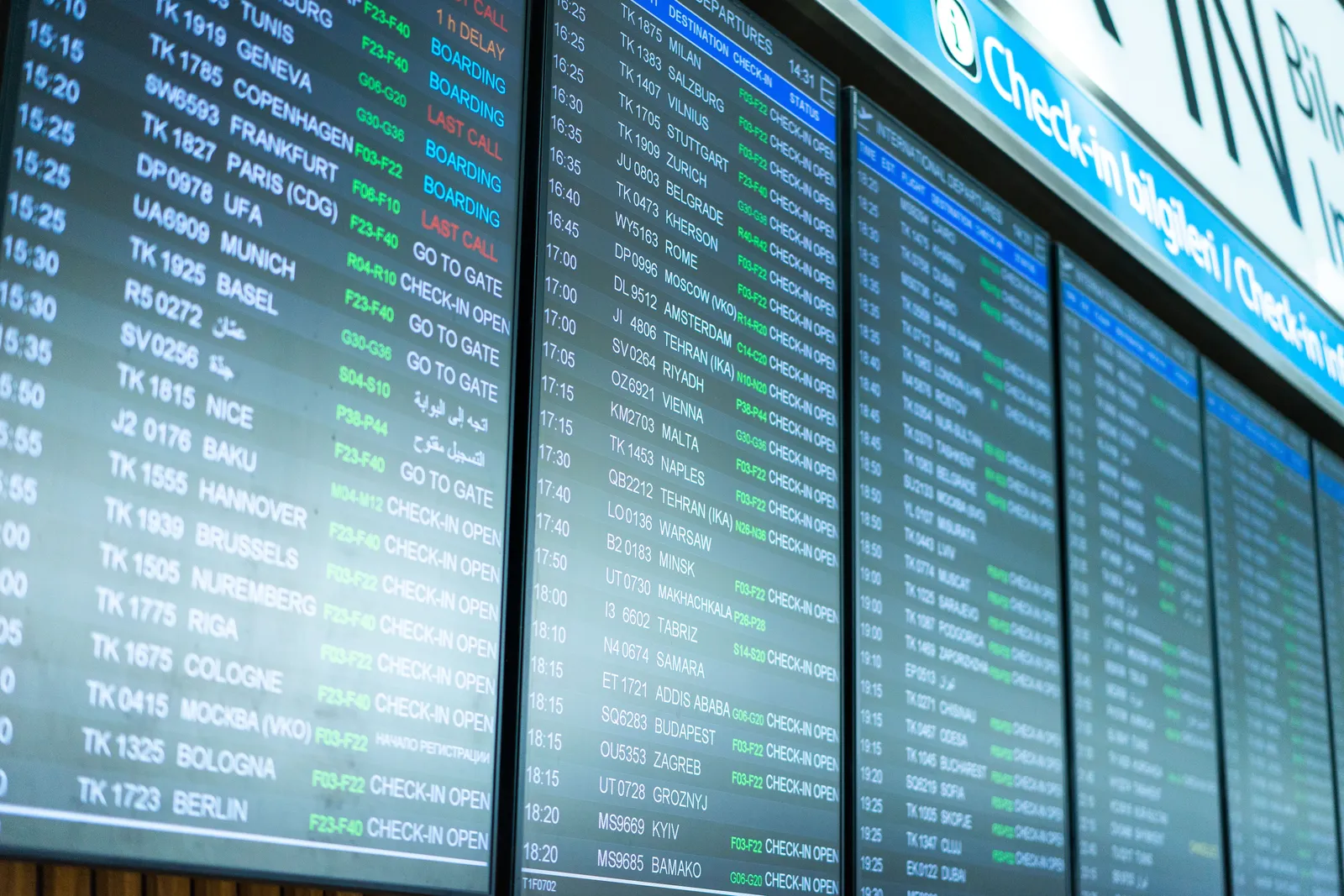 Rows of flight information displayed on an airport departures board