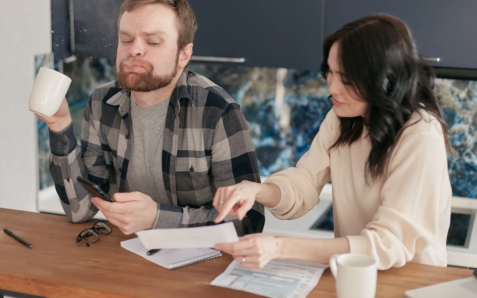 Family reviewing mortgage documents at kitchen table