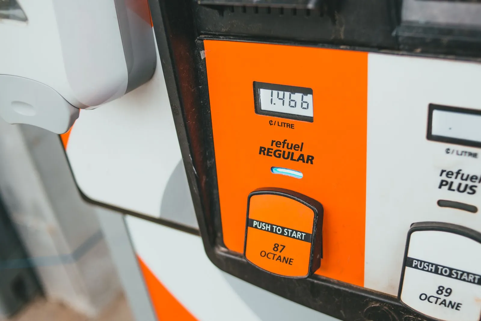 Close-up of a gas station price display with regular and premium fuel grades