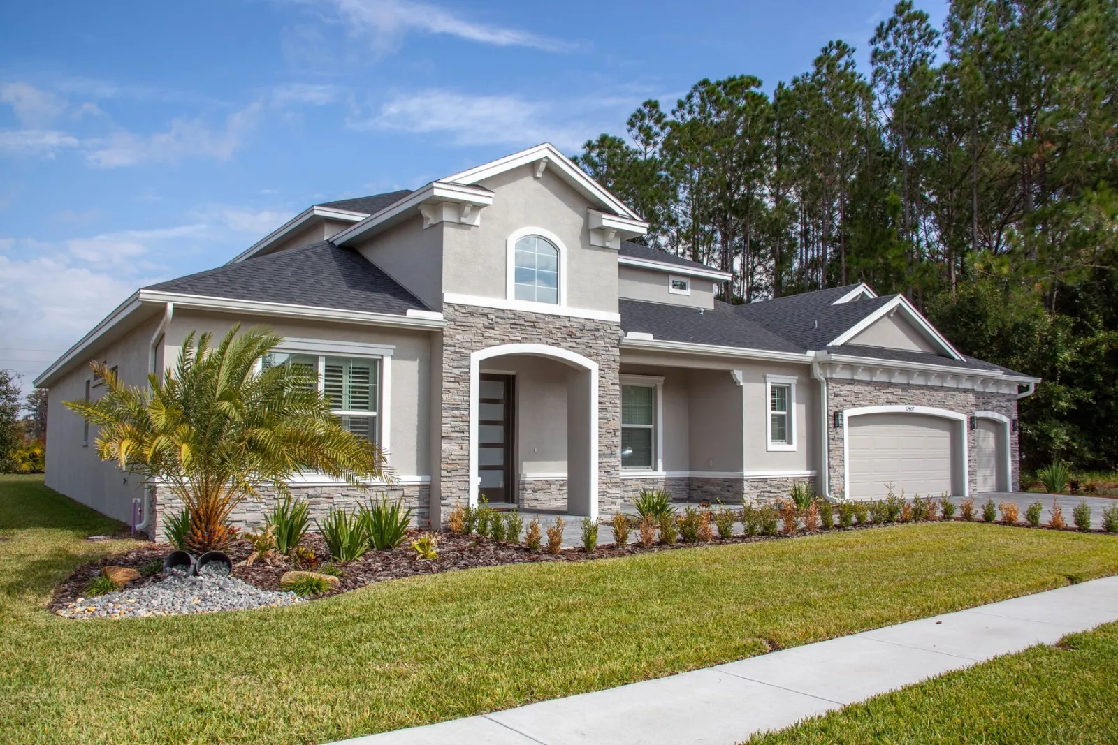 Suburban home with palm trees and a clear sky on a quiet residential street