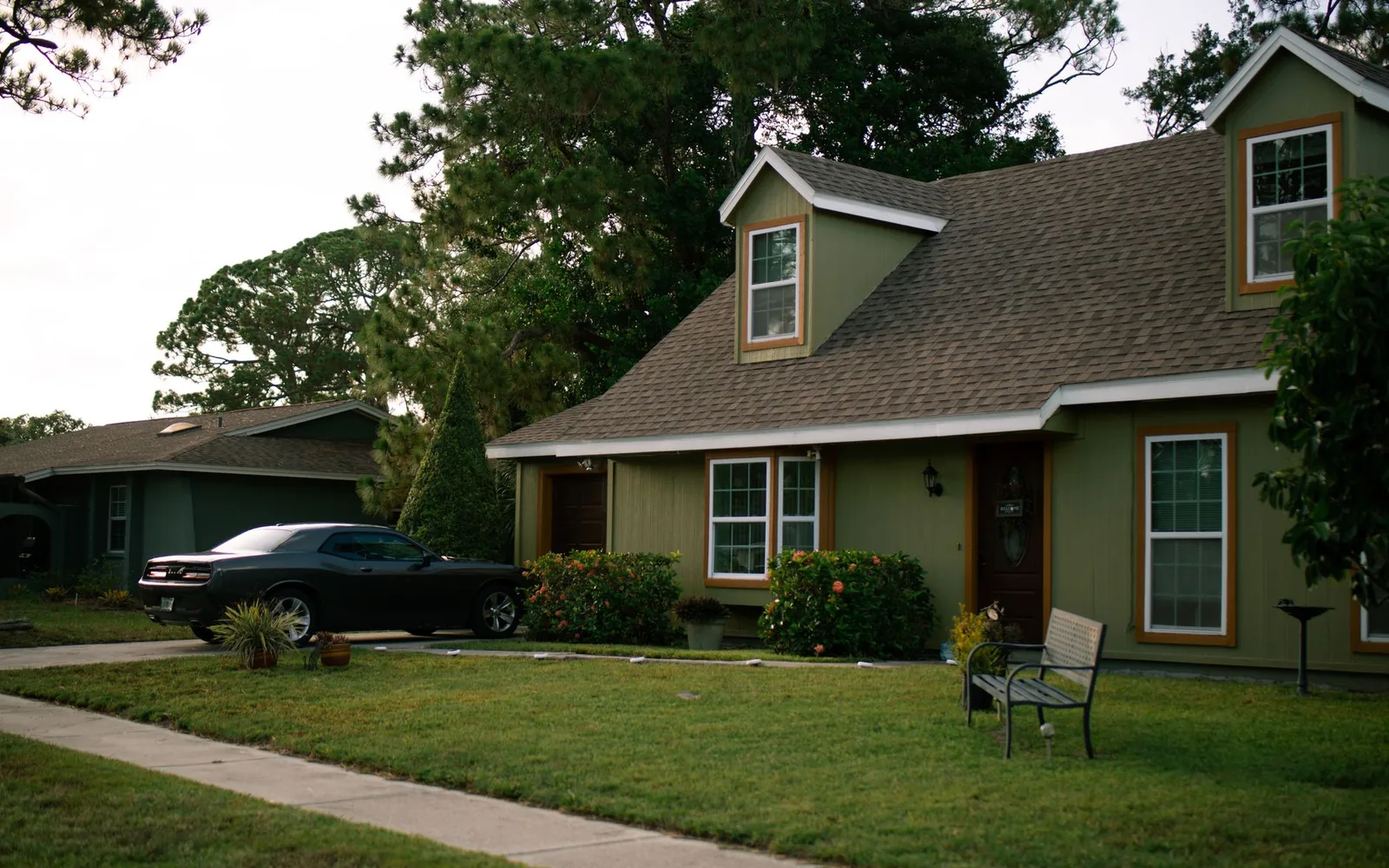 A suburban house with a front porch on a quiet residential street