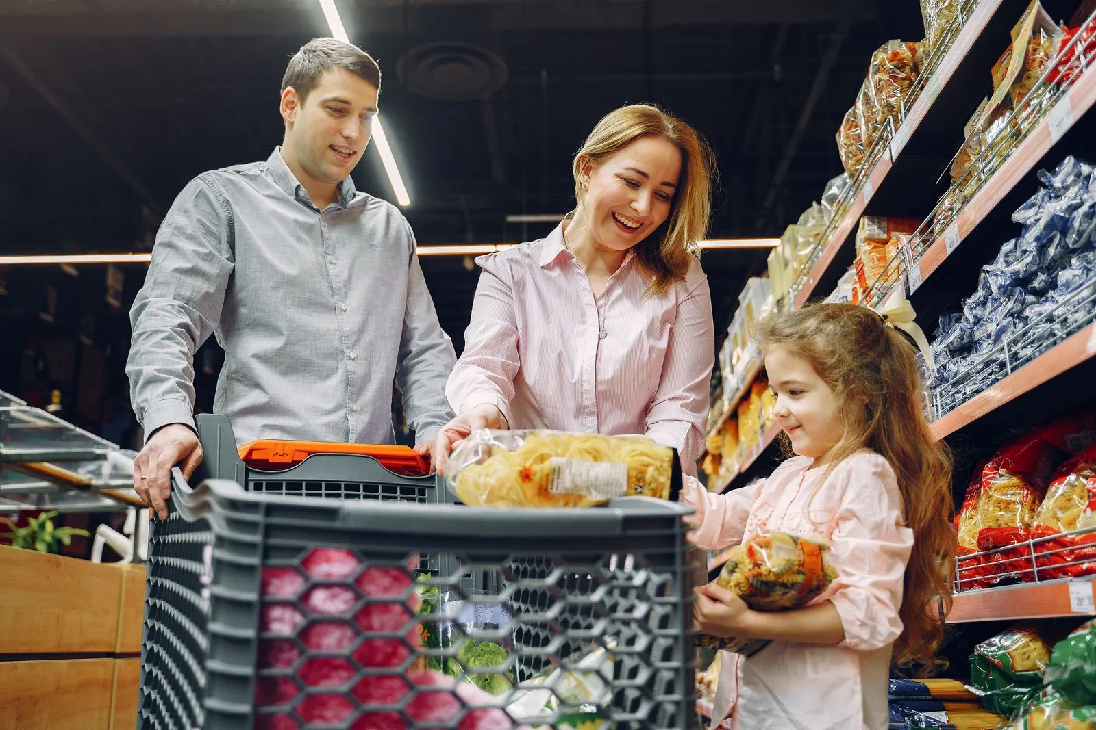 A family shopping together in a bright supermarket aisle