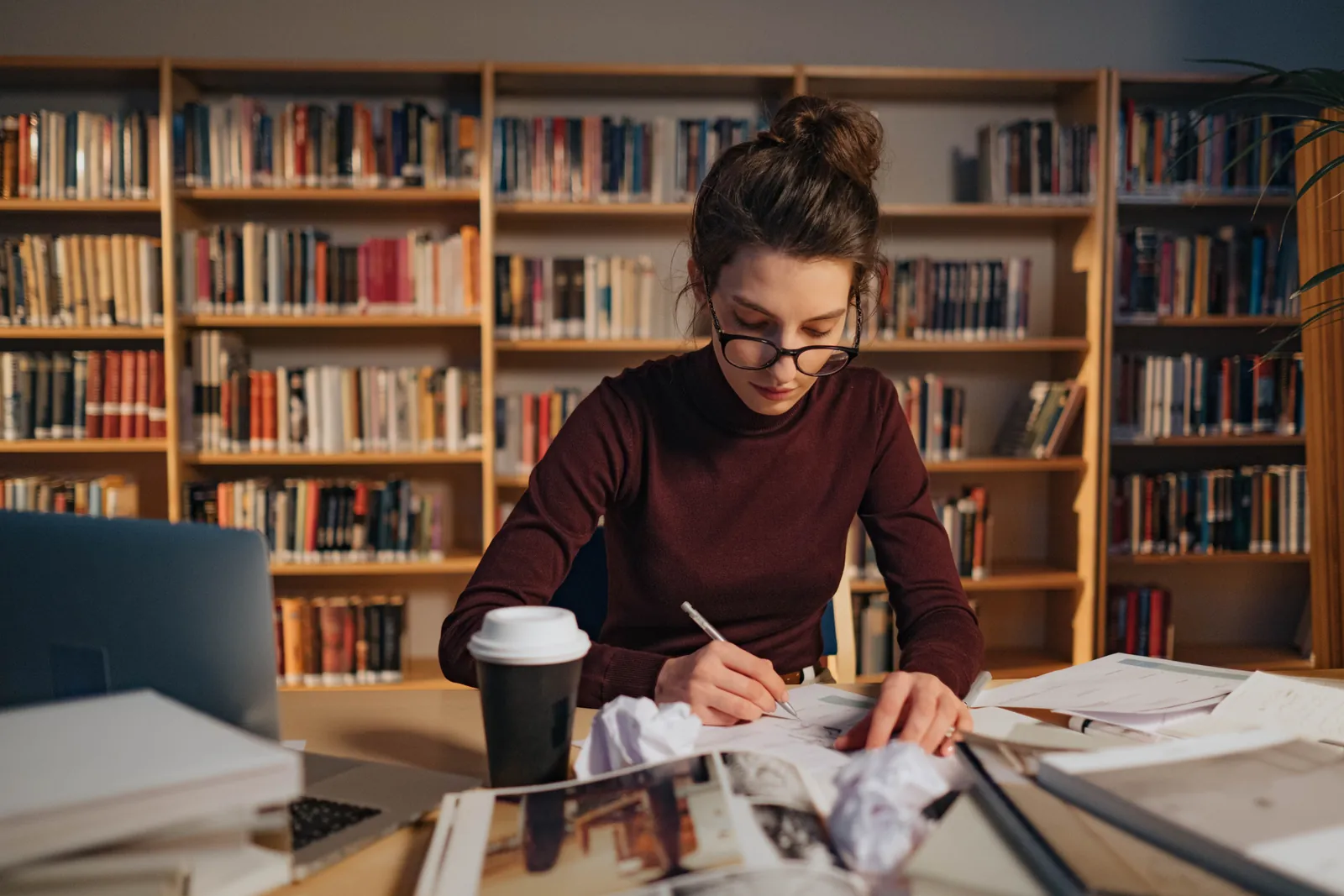 Graduate reviewing student loan paperwork on a laptop at home