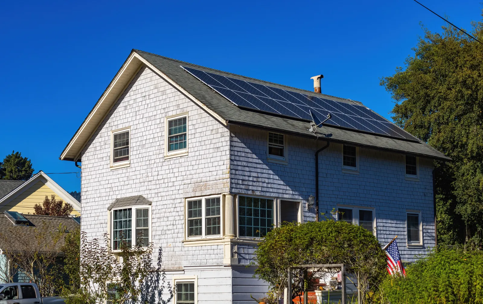 Rooftop solar panels on a suburban single family home under a clear sky