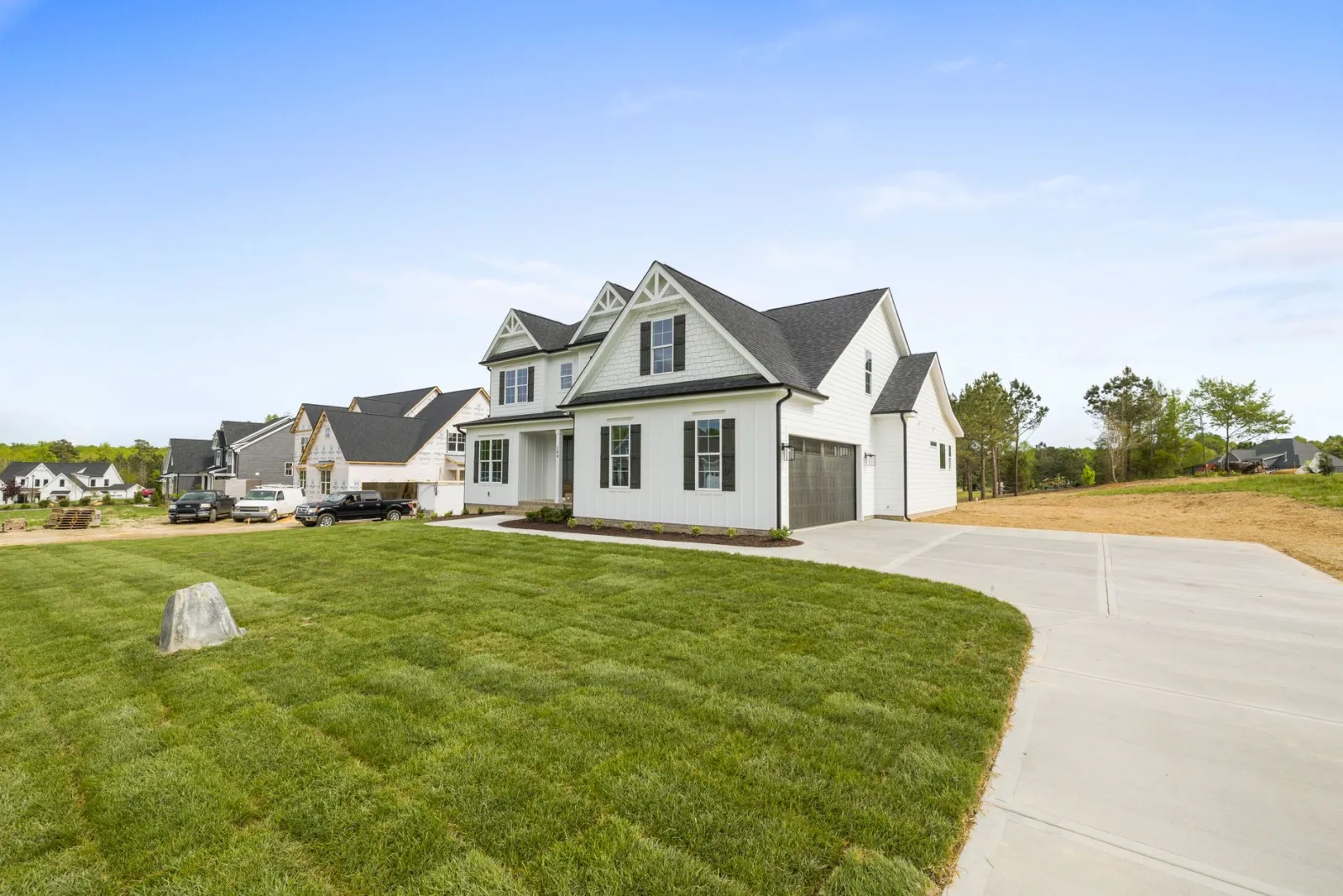 A suburban house with a large front yard on a quiet residential street