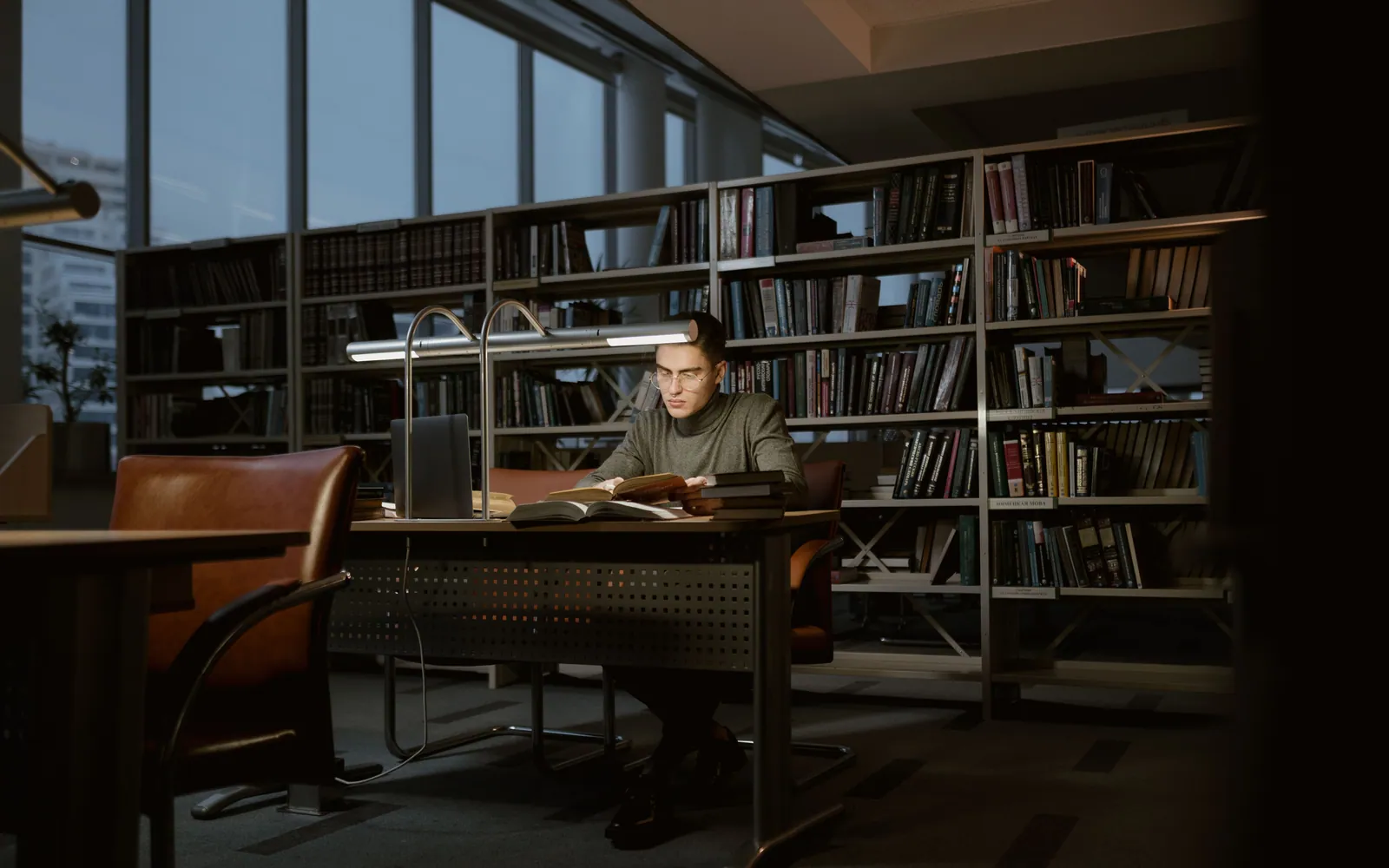 Graduate student studying in a library