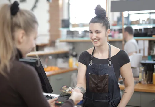 Person paying with credit card at cafe